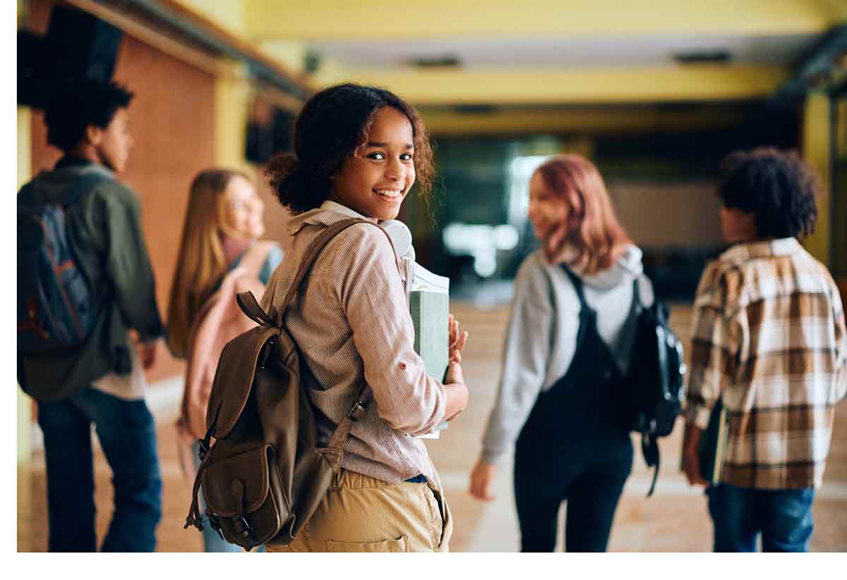 An engaged HDSB Student Walking down a high school hallway